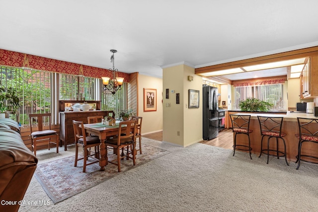 5299 W Green Ct # 5, Rathdrum, ID 83858 - dining area featuring light colored carpet, a chandelier, baseboards, and ornamental molding