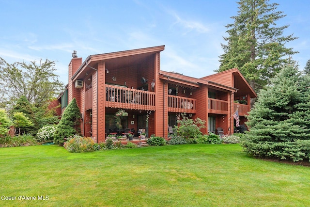 5299 W Green Ct # 5, Rathdrum, ID 83858 - rear view of house with a chimney, a lawn, and a wall mounted AC