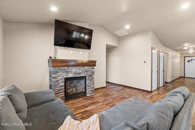 living room featuring a fireplace, dark hardwood / wood-style flooring, and lofted ceiling