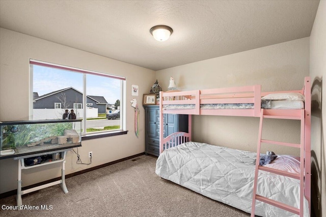 bedroom featuring carpet floors and a textured ceiling