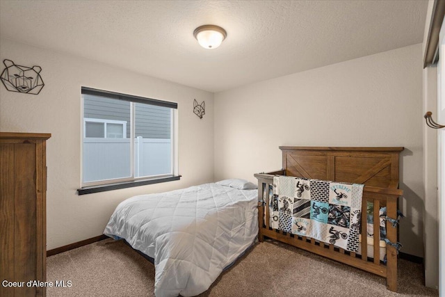 bedroom featuring carpet flooring and a textured ceiling