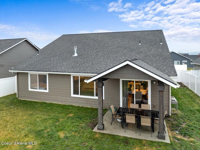 rear view of house with a yard and a patio