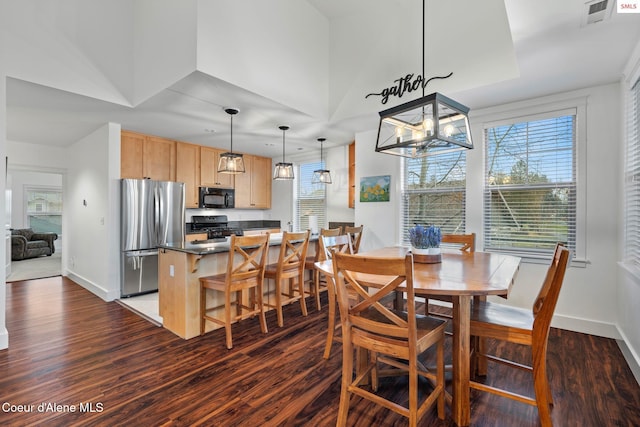 dining room featuring dark wood-type flooring and a notable chandelier