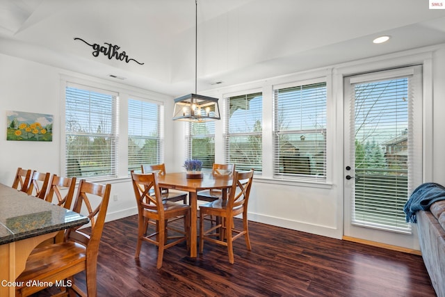 dining space featuring a notable chandelier and dark wood-type flooring