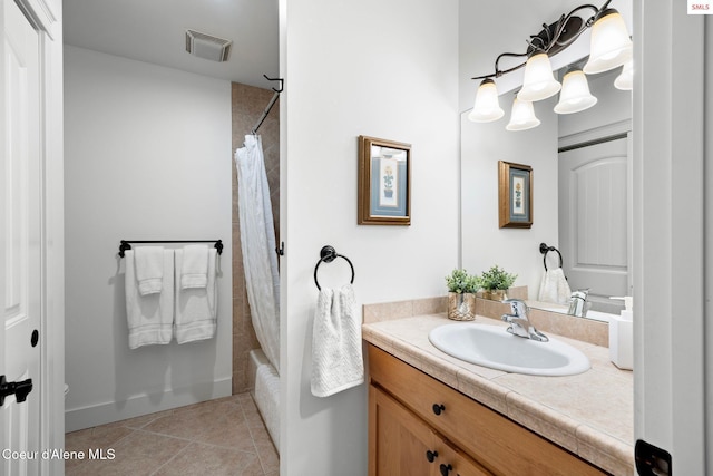 bathroom with tile patterned floors, vanity, and shower / bath combo