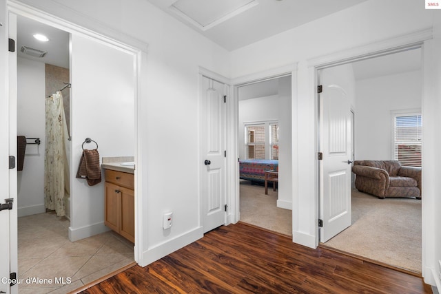 bathroom featuring hardwood / wood-style floors, vanity, and walk in shower