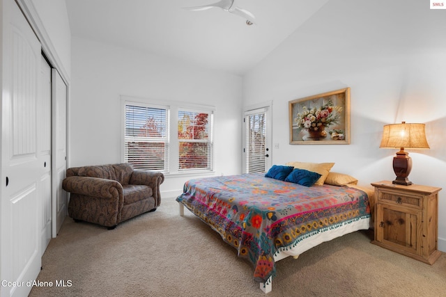 bedroom with ceiling fan, light colored carpet, high vaulted ceiling, and a closet