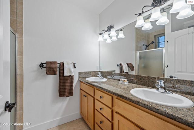 bathroom with tile patterned floors, vanity, and walk in shower