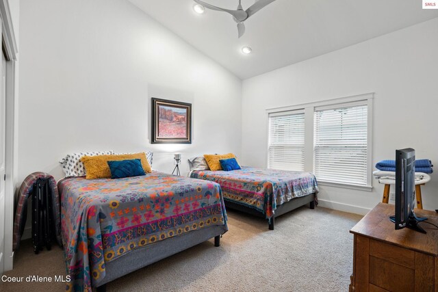 carpeted bedroom with high vaulted ceiling and ceiling fan