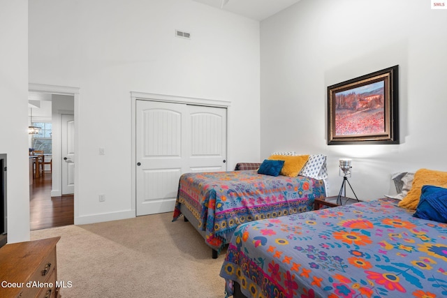 bedroom with light carpet and a closet