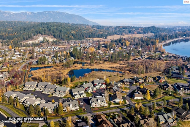 aerial view featuring a water and mountain view