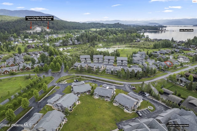 drone / aerial view featuring a water and mountain view