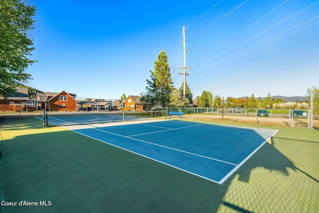 view of tennis court featuring basketball court