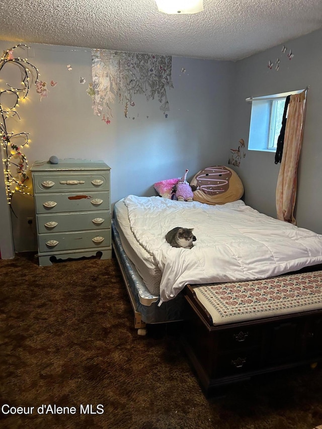 carpeted bedroom with a textured ceiling