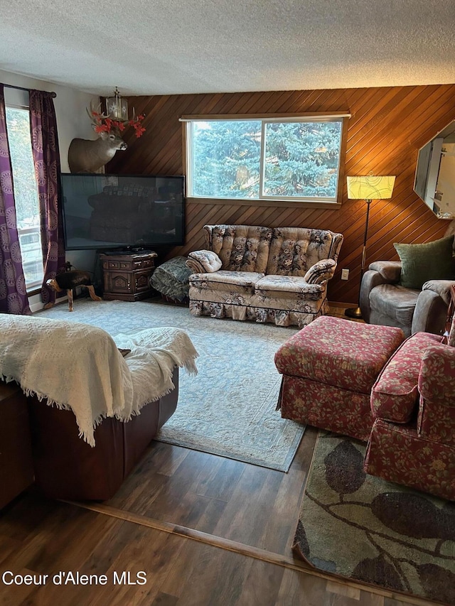 living room featuring hardwood / wood-style floors, plenty of natural light, and wood walls