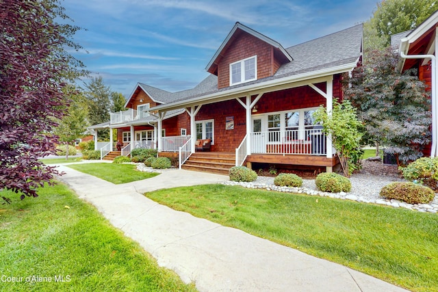 view of front of house with covered porch and a front yard