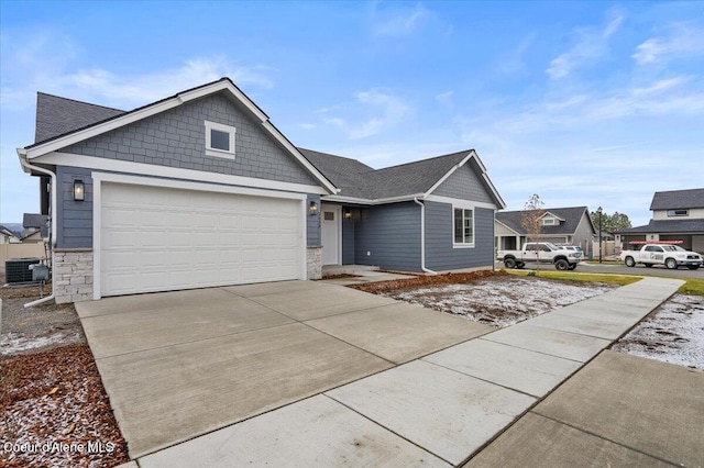 view of front of property featuring central AC unit and a garage