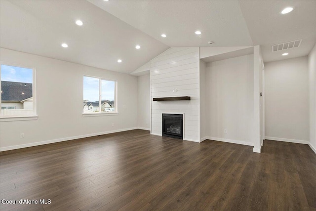 unfurnished living room with a fireplace, dark hardwood / wood-style flooring, and vaulted ceiling