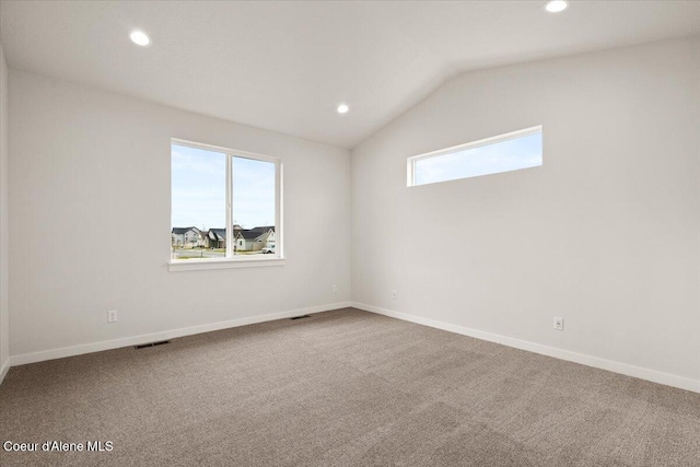 unfurnished room with carpet floors and lofted ceiling