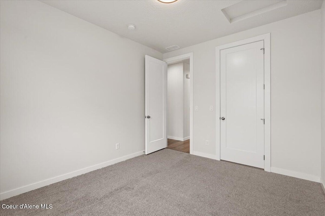 unfurnished bedroom with carpet and a textured ceiling