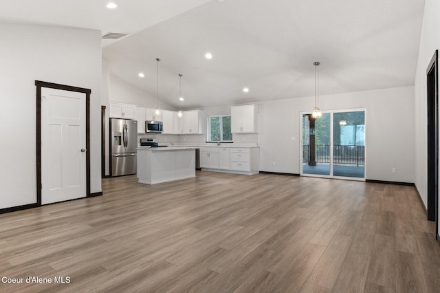 unfurnished living room featuring sink, high vaulted ceiling, and light hardwood / wood-style floors