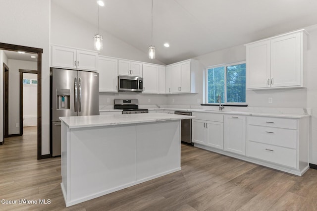 kitchen with a center island, white cabinets, and stainless steel appliances