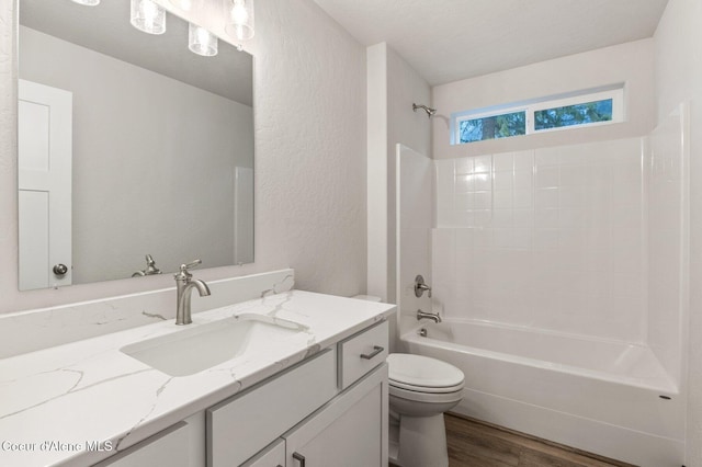 full bathroom with toilet, vanity, shower / bath combination, and hardwood / wood-style flooring