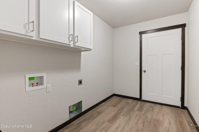 laundry room with electric dryer hookup, cabinets, hookup for a washing machine, light wood-type flooring, and a textured ceiling