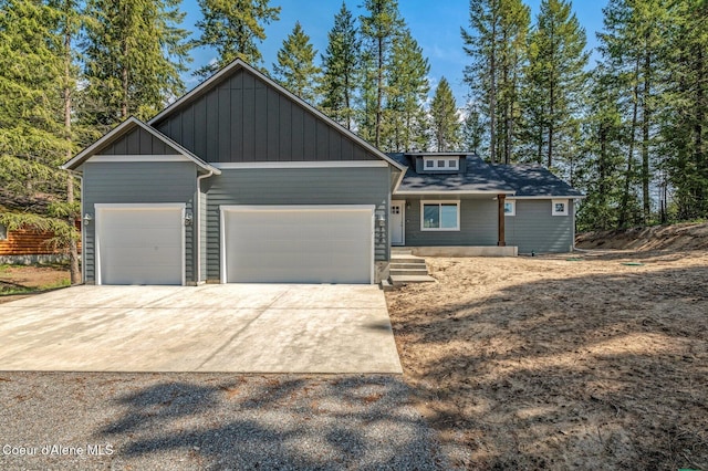 craftsman inspired home with concrete driveway, board and batten siding, and a garage