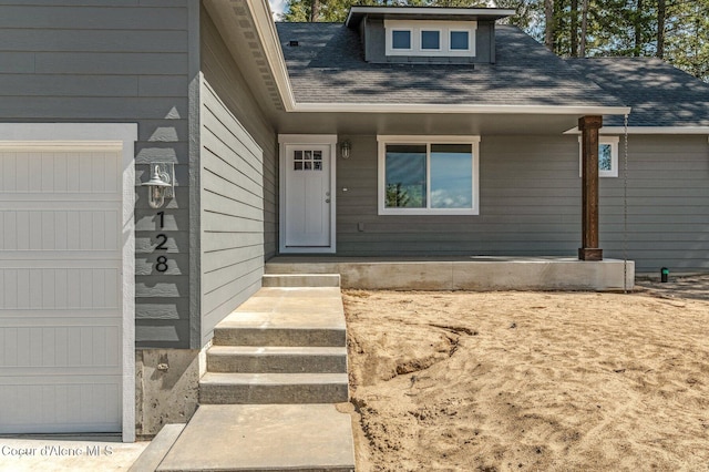 property entrance featuring roof with shingles