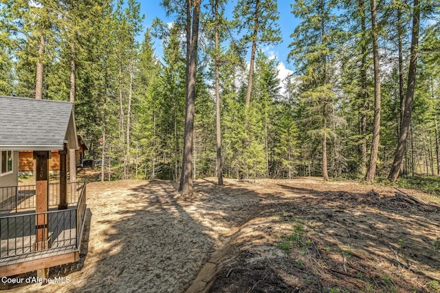 view of yard featuring a forest view