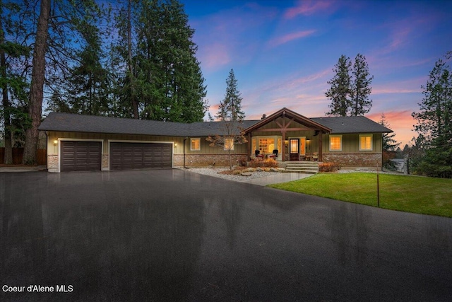 view of front of home with a yard and a garage