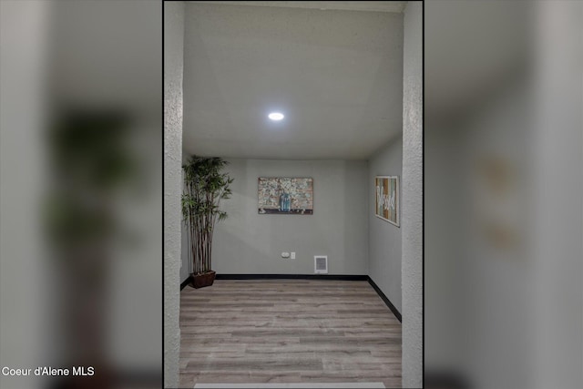 corridor featuring light hardwood / wood-style floors