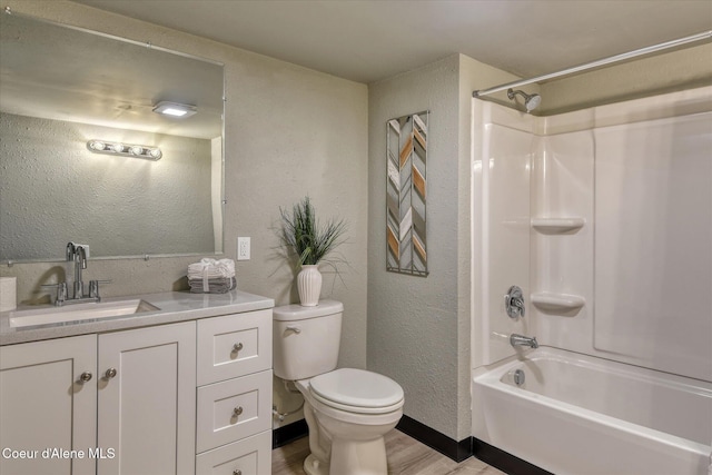 full bathroom featuring washtub / shower combination, hardwood / wood-style floors, vanity, and toilet