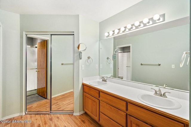 bathroom with hardwood / wood-style floors and vanity