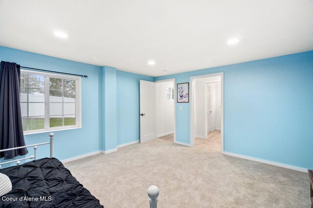 unfurnished bedroom with light colored carpet