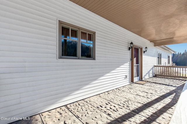 wooden terrace featuring covered porch