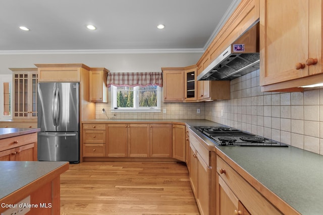 kitchen featuring stainless steel refrigerator, light hardwood / wood-style flooring, ventilation hood, crown molding, and decorative backsplash