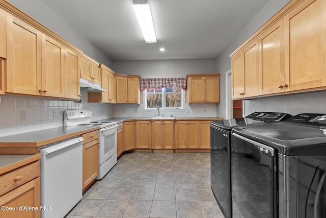 kitchen featuring white appliances, sink, light brown cabinetry, tasteful backsplash, and washing machine and clothes dryer