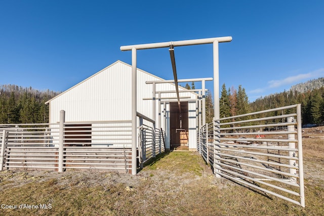 view of side of home featuring an outbuilding