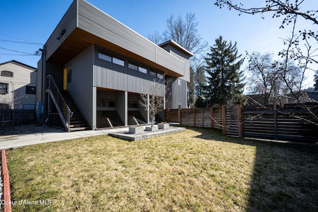 back of property featuring a patio area and a lawn