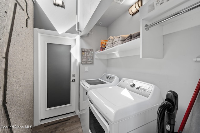 laundry room with washing machine and dryer and dark hardwood / wood-style floors