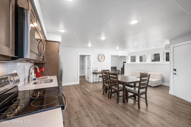 dining room with light hardwood / wood-style floors and sink