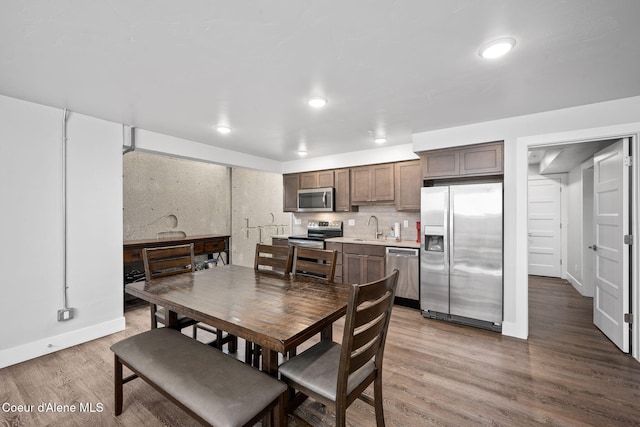 dining area featuring wood-type flooring and sink