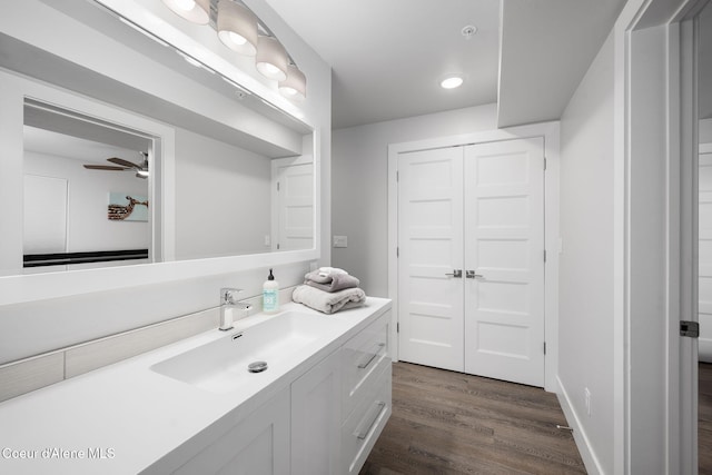 bathroom featuring wood-type flooring, vanity, and ceiling fan