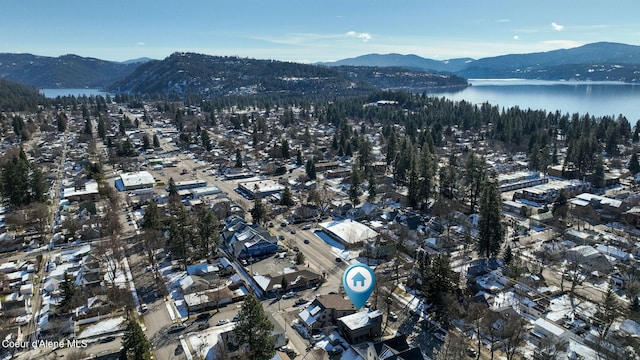 drone / aerial view featuring a water and mountain view