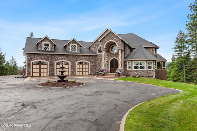 french provincial home with a front lawn