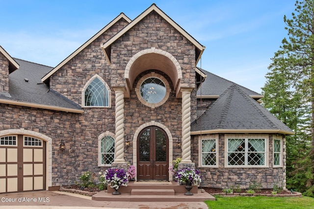 view of front facade with a garage and french doors