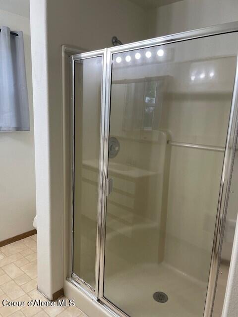 bathroom featuring tile patterned flooring and walk in shower