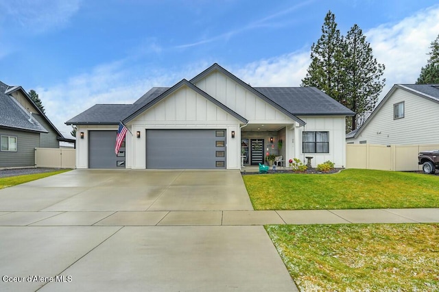 view of front of home featuring a front yard and a garage